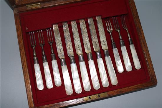 A late Victorian cased set of six pairs of mother of pearl handled silver dessert eaters,